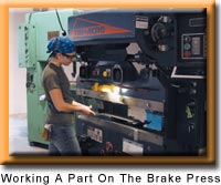 Working a part on the brake press 